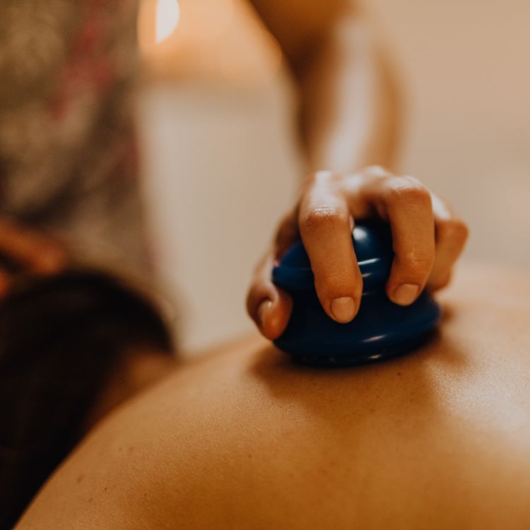 Close-up silicone cupping therapy massage on back for muscle recovery and pain relief at wellness spa